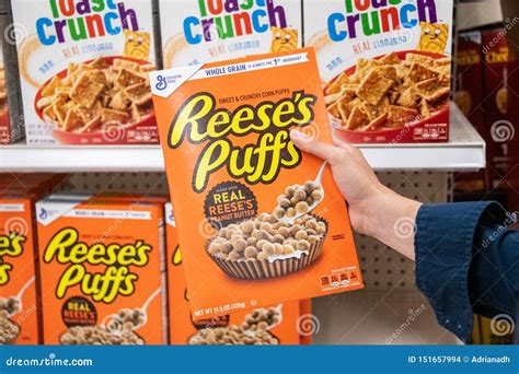 Shoppers Hand Holding a Package of General MIlls Reese`s Puffs Brand ...