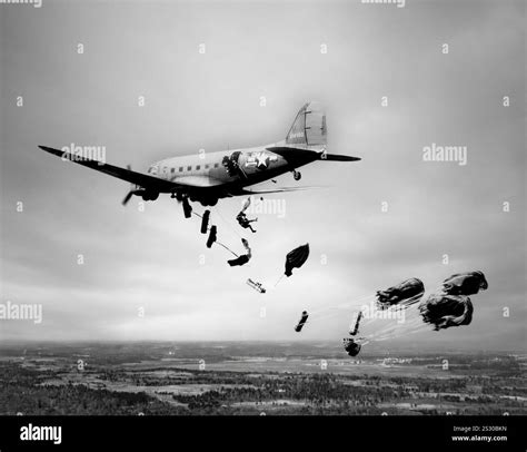 Equipment and troops baling out from a Douglas Dakota C-47 troop ...