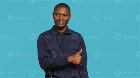 Portrait of security guard doing no gesturing with finger, prohibiting ...