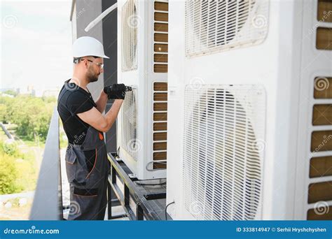 Young Man Repairman Checking an Outside Air Conditioner Unit Stock ...