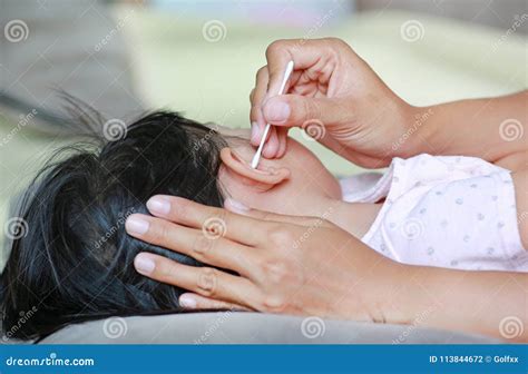 Mother Cleaning Baby Ear with Cotton Swab. Stock Photo - Image of ...