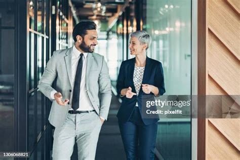 Two Business People Walking Side by Side 的图像结果