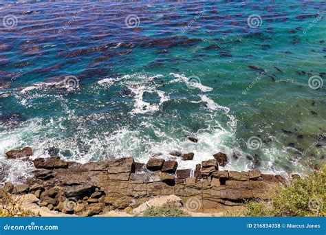 Deep Blue Ocean Waves Crashing into Square Shaped Rocks on the Shores ...