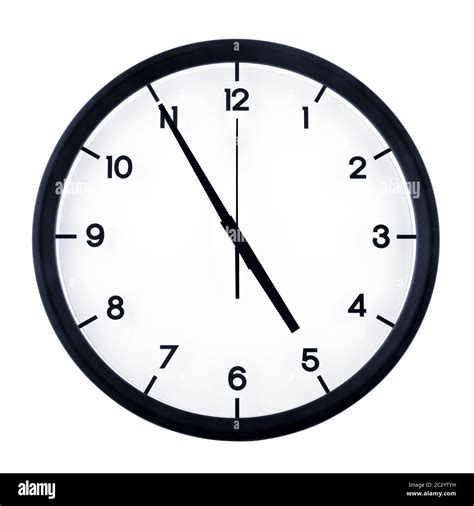 Classic analog clock pointing at four fifty five, isolated on white ...