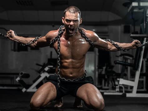 Muscular man slave in chains in gym, the prisoner | Premium Photo