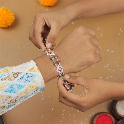 Silver Rakhi with Rudraksha and Two Om Symbols, Double Line Design ...