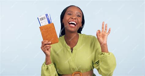 Premium Photo | Black woman passport and ok sign for studio portrait with airplane ticket ...