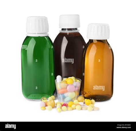 Bottles of syrups, measuring cup with pills on white background. Cough ...