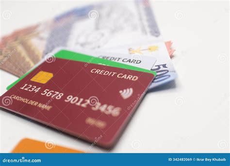 Maroon Credit Card on Saudi Riyal Banknotes Stack . Stock Image - Image ...