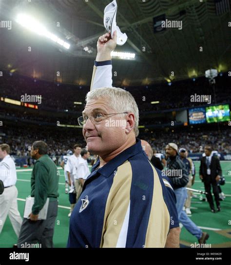 St. Louis Rams head football coach Mike Martz waves to the crowds as he ...