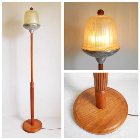 Mid century teak floor lamp with a vintage holophane street lamp shade