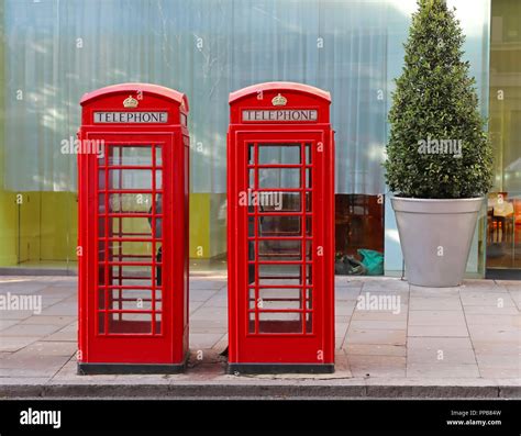 Two red telephone booths in central London Stock Photo - Alamy