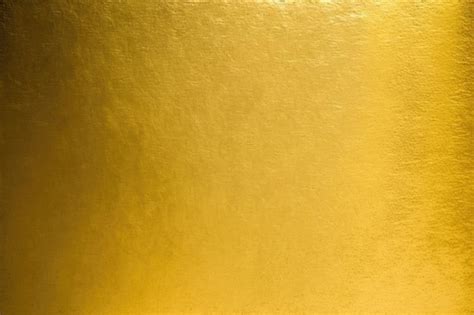 Bright and reflective gold metal surface with abstract patterns and ...