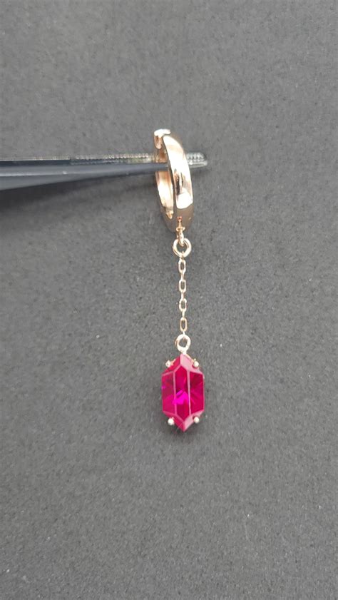Made a zelda inspired earring with a created ruby rupee I cut! The ruby is 10x5.5mm and is about ...