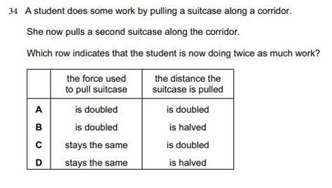 A student does some work by pulling a suitcase along a corridor. She ...