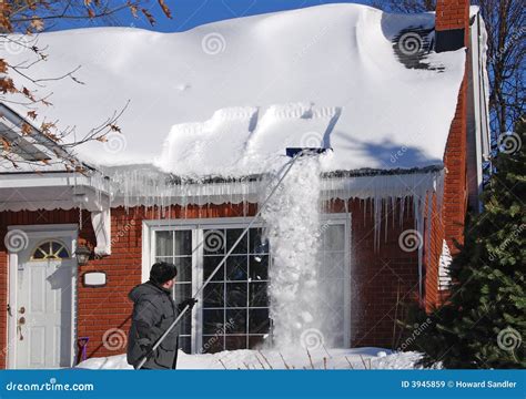 Raking Snow off the Roof stock image. Image of house, snowdrift - 3945859