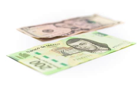 Premium Photo | 200 mexican pesos bill with a 5 dollar bill out of ...