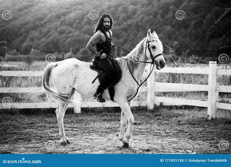 Full Length of Young Handsome Man Sitting on His White Stallion at the ...