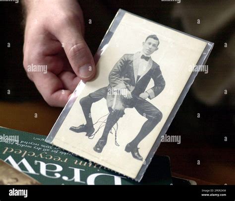 Artist James Mundie holds an old photograph showing Frank Lentini ...