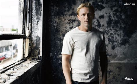 Daniel Craig With Black And White Old Cottage Background
