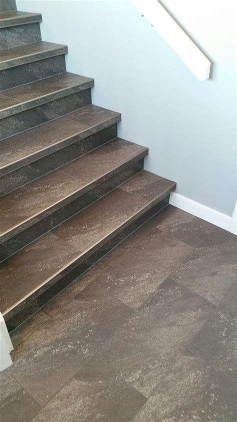 Luxury vinyl tile installed with custom insert stair nosings. More Tile ...
