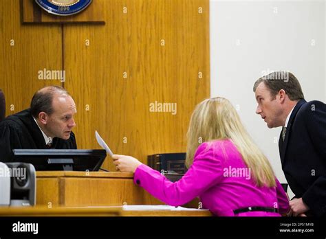 Judge Derek Pullan, left, speaks to defense attorney Susanne Gustin ...