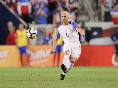 Download Michael Bradley Kicks Soccer Ball Wallpaper | Wallpapers.com