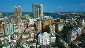 Dar es Salaam, Tanzania: Drone soars over blue waves and tall towers