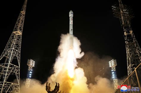 North Korea claims it launched first spy satellite, promises more | Reuters