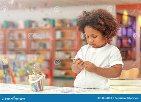 Little Toddler Girl Concentrate on Drawing. Mix African Girl Learn and Play in the Pre-school ...