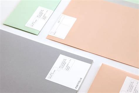 Corporate Design: Three Colored Envelopes on White Table