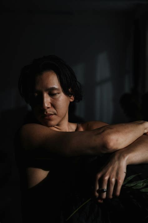 Nude Man with Black Hair Posing in Dark Space · Free Stock Photo