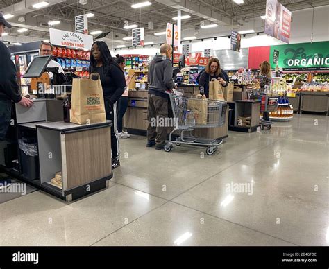 Orlando,FL/USA-12/14/19: Grocery store employees scanning food items at the check out stations ...