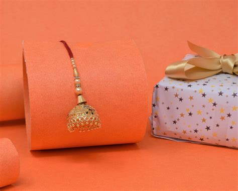 Elegant Jhumka Rakhi with Roli Chawal and Raksha Bandhan Greeting Card ...