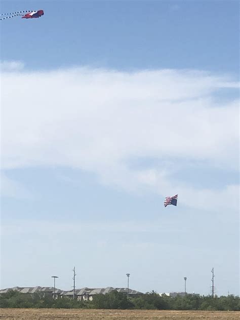 Someone is flying a kite and an upside down flag at North Lakes Park ...