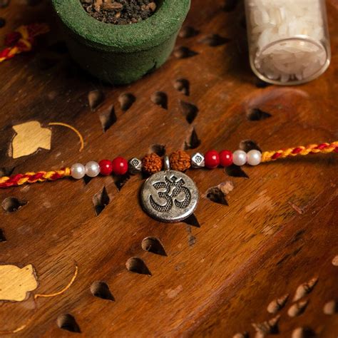 Buy Divine Golden Om Rudraksha Rakhi Online in India - Mypoojabox.in