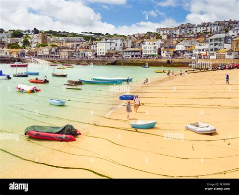 ST IVES, ENGLAND - JUNE 19: People enjoying the golden sands of St Ives ...