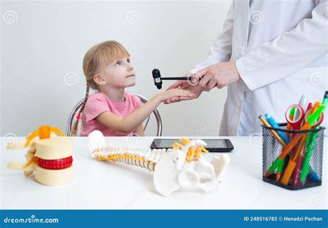A Neuropathologist Checks The Mandibular Reflex In A 5-year-old Girl. Close-up, Neurologist ...