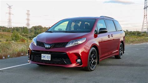 Download Red Toyota Sienna Minivan Parked Outdoors Wallpaper | Wallpapers.com