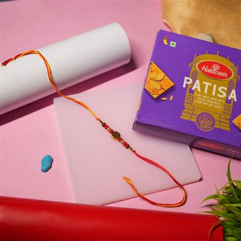 Send Sacred Om Rudraksha Rakhi with Patisa Bliss Online