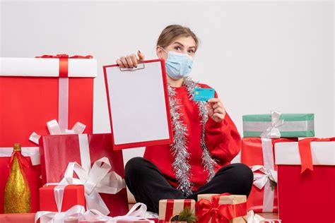 Front view young female sitting around presents with note and bank card ...
