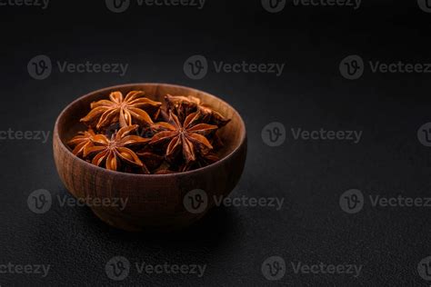 Star shaped spice star anise in a wooden round bowl 24121205 Stock ...