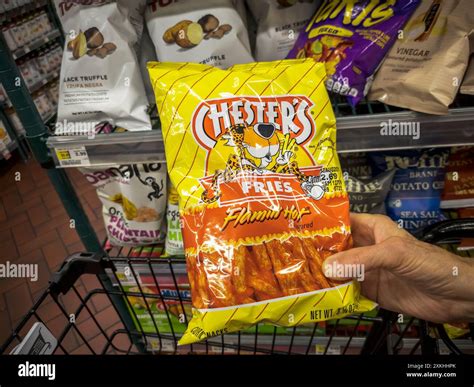 A shopper chooses a package of Chester’s Flamin’ Hot Fries in a ...