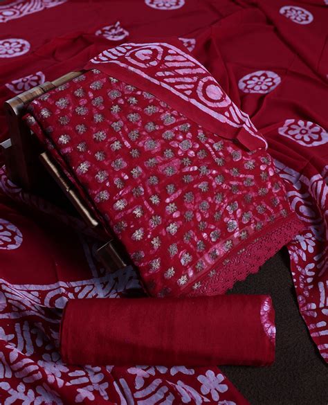 Maroon colour churidhar material adorned with gold and copper toned fl