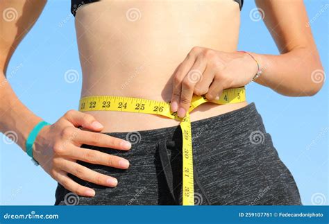 Thin Girl Measures Her Waist with the Flexible Measuring Tape Stock ...