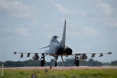 Royal Air Force ground crew preparing an RAF Typhoon fighter jet. It is night-time and the team are