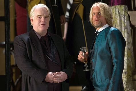 Phillip Seymour Hoffman as Plutarch Heavensbee and Woody Harrelson as ...