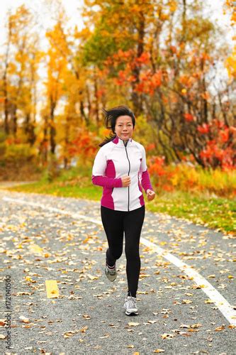 Middle aged mature Asian woman running healthy lifestyle Chinese lady ...