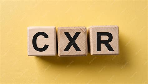 Wooden cubes with abbreviation CXR yellow background Chest XRay Medical concept Flat lay ...