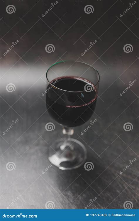 Glass of Intensely Coloured Red Wine on Dark Background Stock Image ...